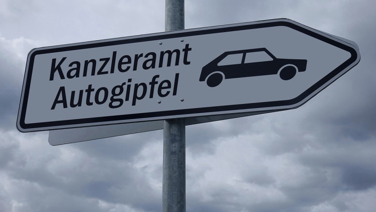 Auf einem Wegweiser stehen die Schriftzüge Kanzleramt und Autogipfel.
