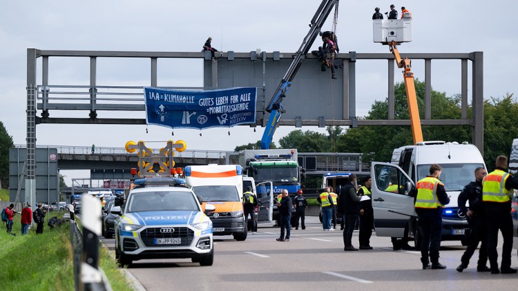 IAA-Gegner werden von Einsatzkräften der Polizei von einer Schilderbrücke auf der A9 abgeseilt.