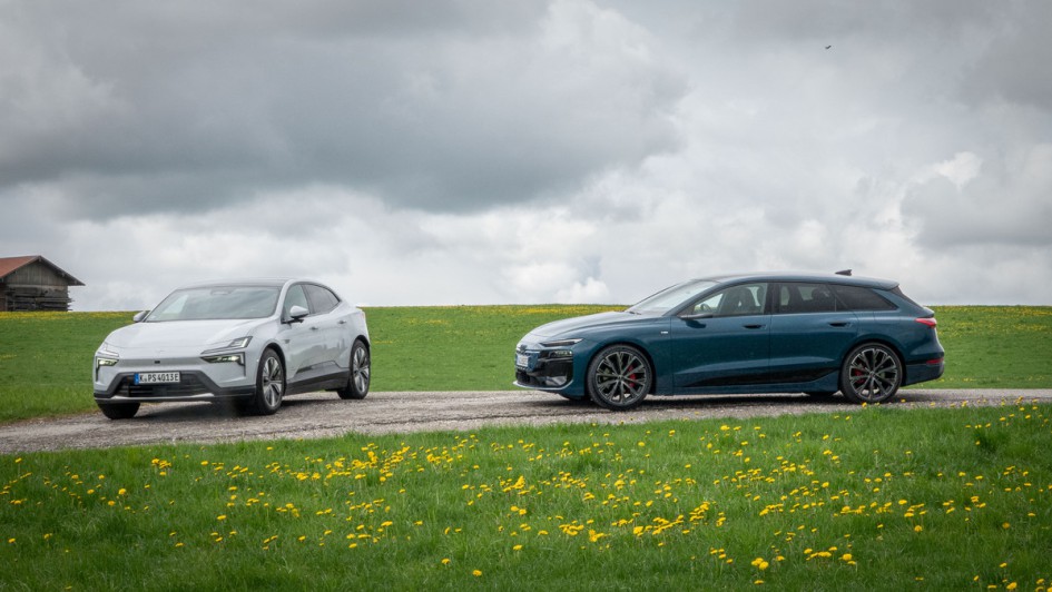 Polestar 4 und Audi A6 Avant e-tron auf Asphalt stehend vor grüner Wiese. 